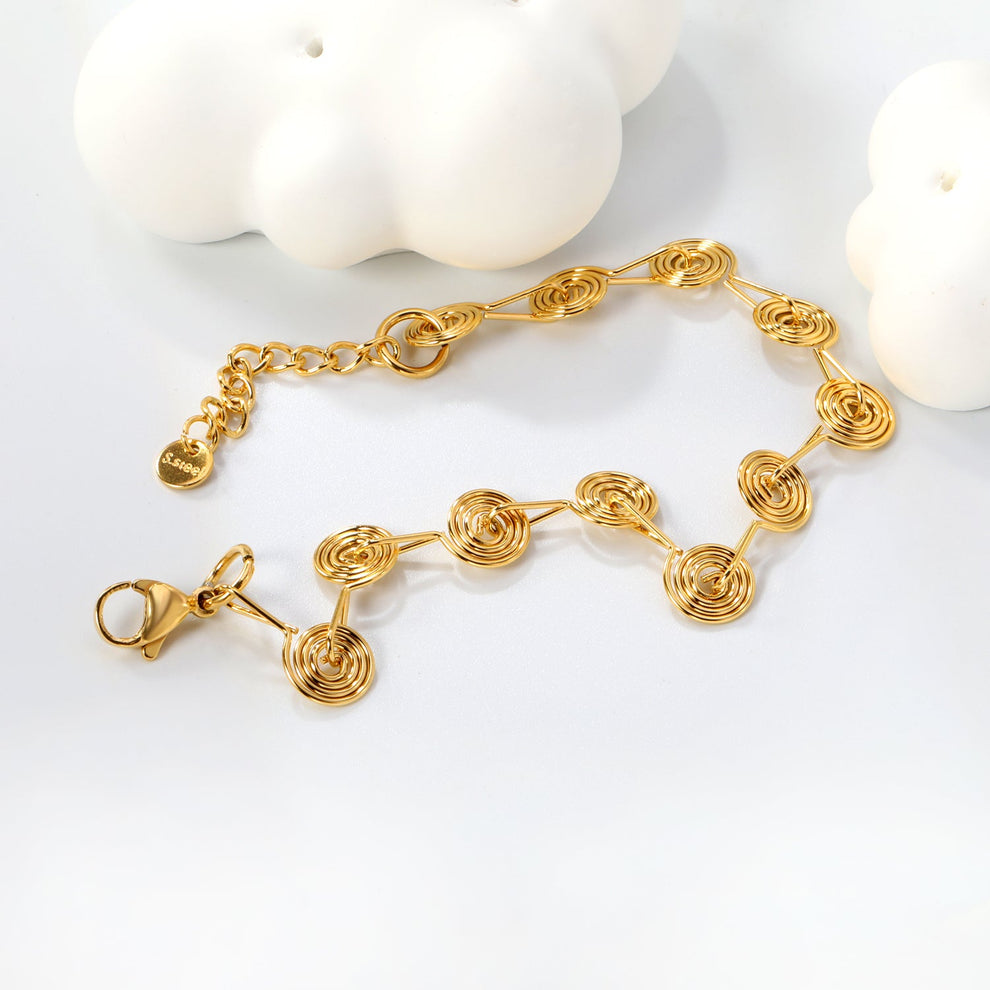 Pulsera Espirales Waterproof: elegancia y arte en acero inoxidable y oro 18K. Resistente al agua, diseño único en eslabones espiral. ¡Descúbrela!