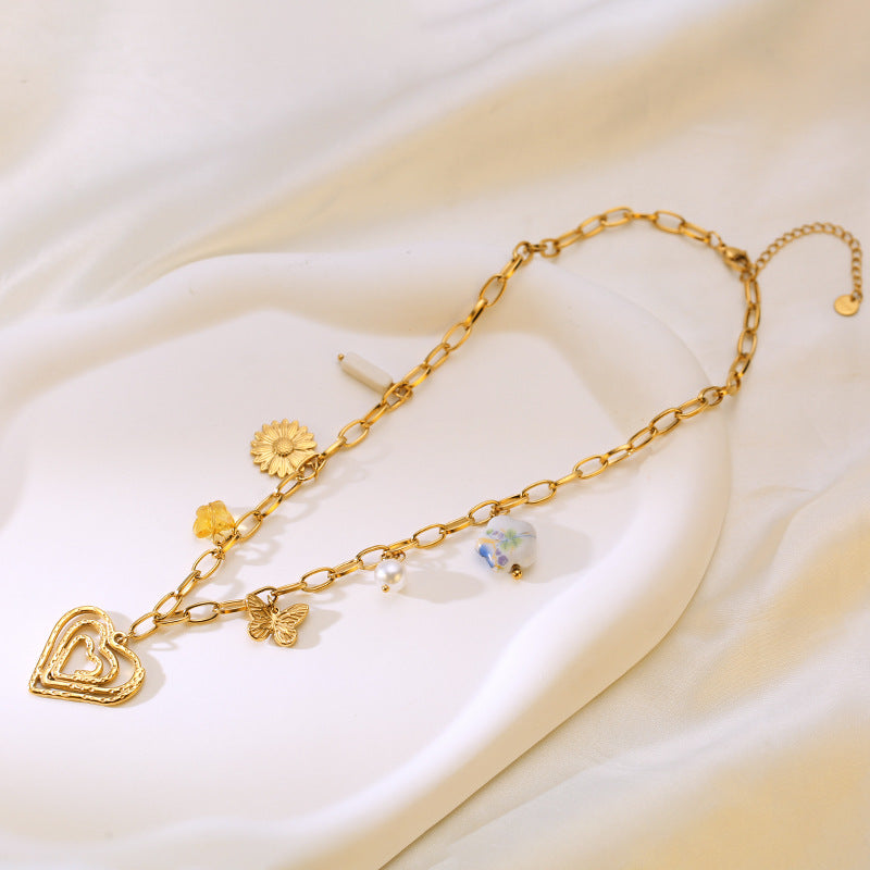 Collar waterproof con charms florales dorados. Acero 316L enchapado en oro 18k: no se oxida ni mancha. Envío a todo el Perú